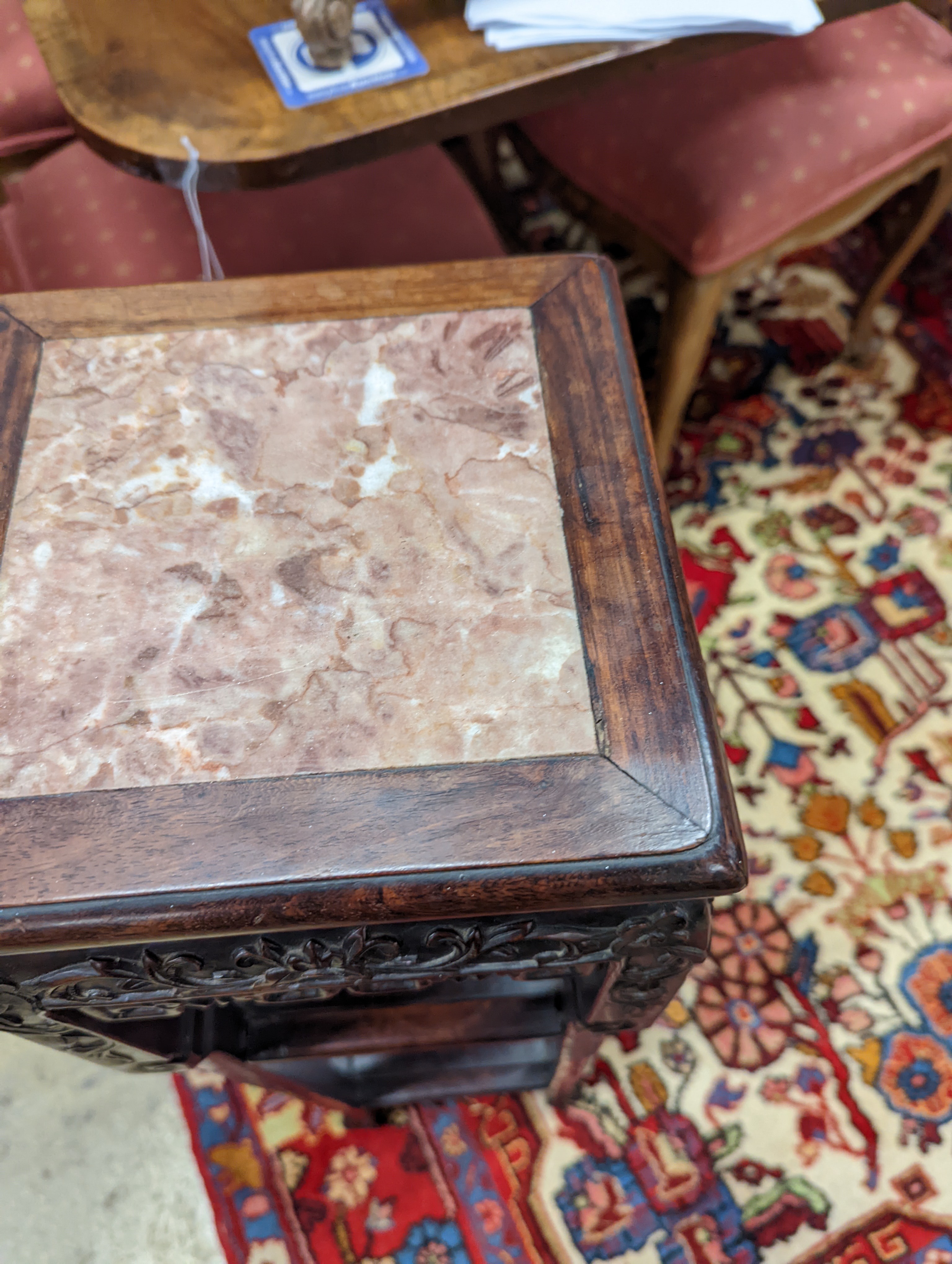 A Chinese carved hardwood three tier jardiniere stand, marble inset, width 22cm, depth 22cm, height 82cm